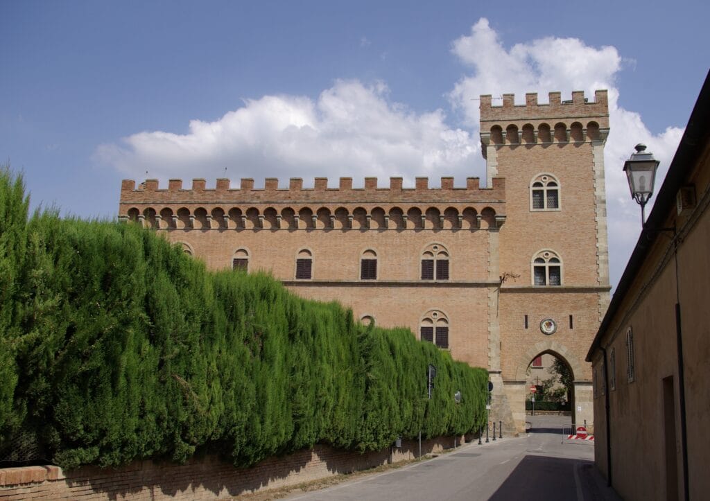 Castle entrance of Bolgheri, Tuscany with medieval brick architecture and arched gate