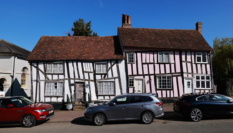 Leaning Tudor-style houses with timber frames and pastel colors in Lavenham, England