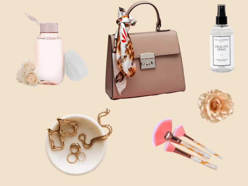 Flatlay with fashion and beauty cleaning essentials – makeup remover, delicate spray, handbag, jewelry, and makeup brushes on beige background