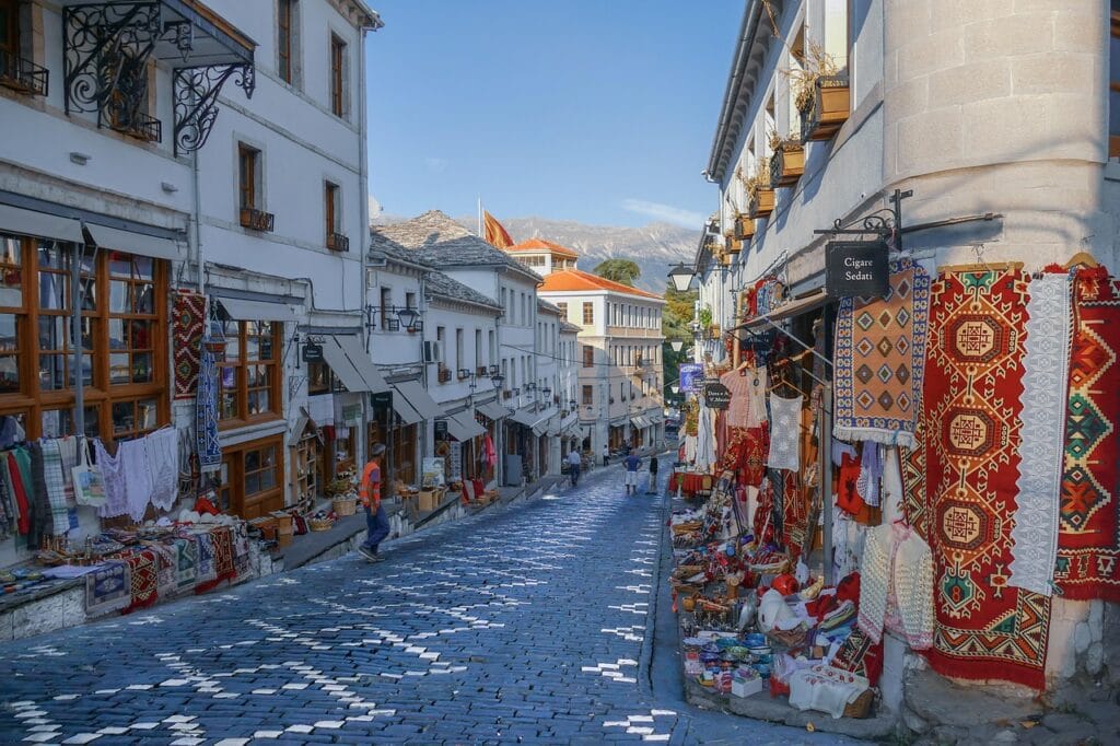 Traditional street market with Ottoman-style buildings and handmade crafts in Gjirokastër, Albania