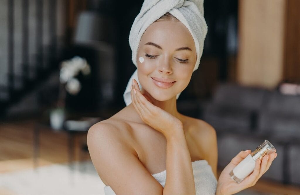 Woman applying hydrating serum on face for minimalist skincare hydration routine