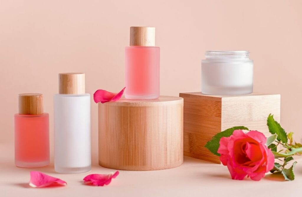 Minimalist skincare products with natural rose accents on a clean, neutral background