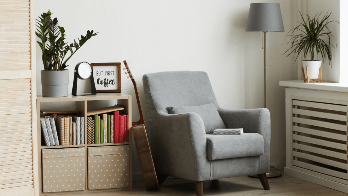cozy reading nook with grey armchair and bookshelf – feminine home decor idea