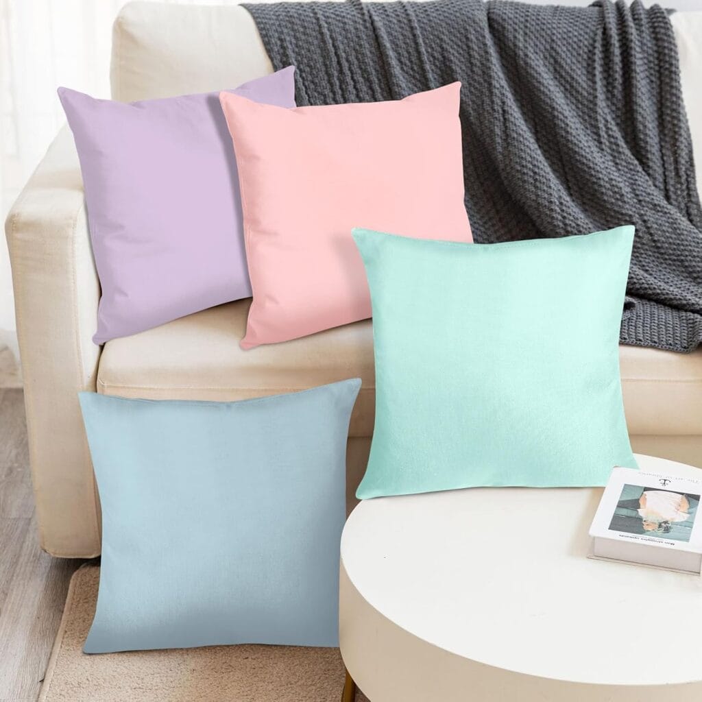 pastel throw pillows in pink, lavender, mint and blue on a neutral sofa – soft feminine home decor idea
