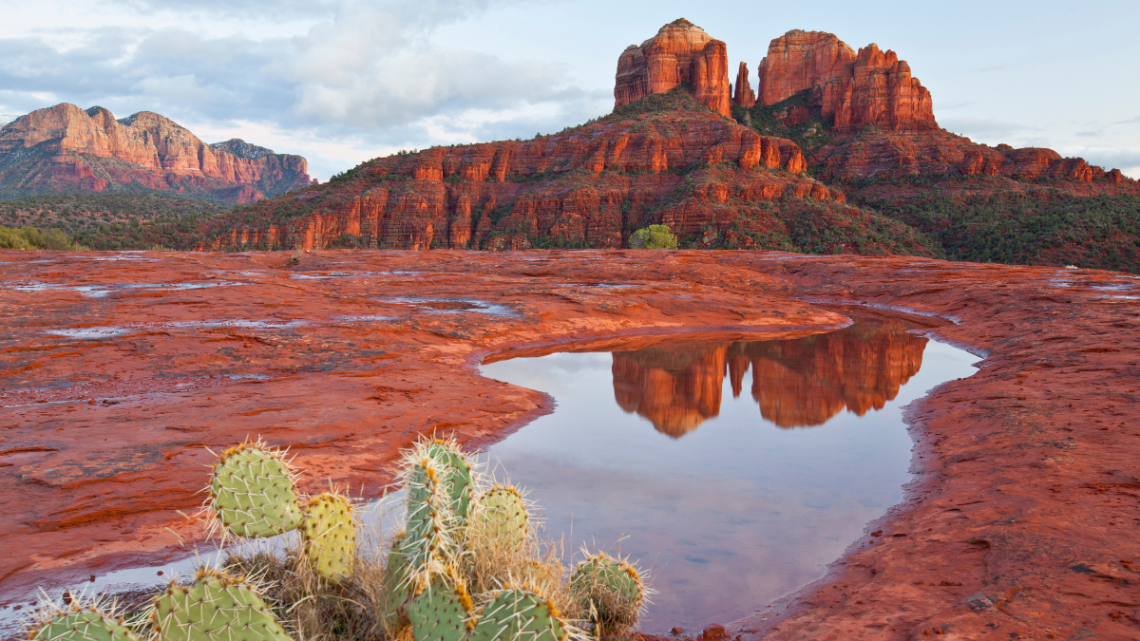 Iconic view of Cathedral Rock reflected in a water pool, Sedona, Arizona