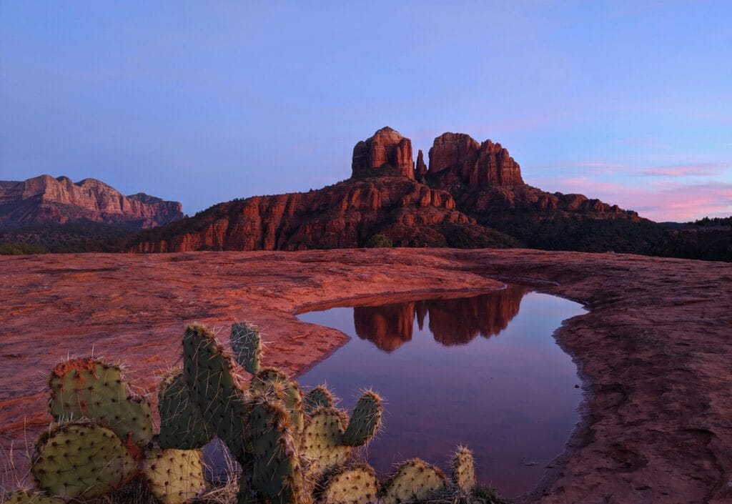 Cathedral Rock at sunset reflected in a desert pool, Sedona’s iconic view.