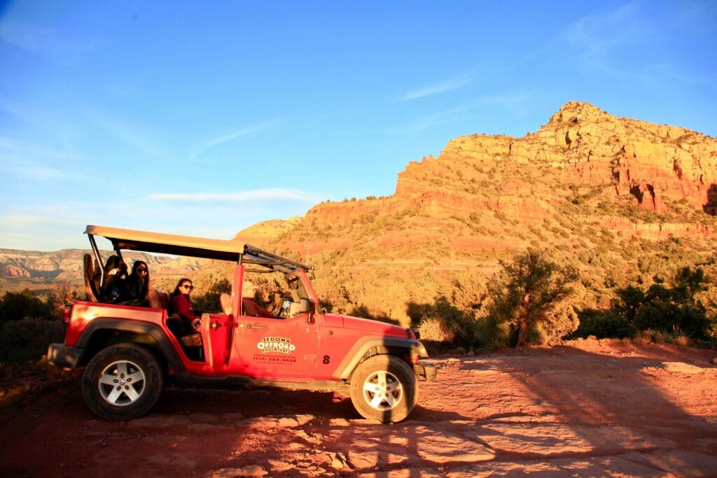 Adventure jeep tour exploring Sedona’s red rock landscapes at sunset.