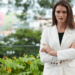 Confident woman wearing a white blazer in a stylish outdoor setting