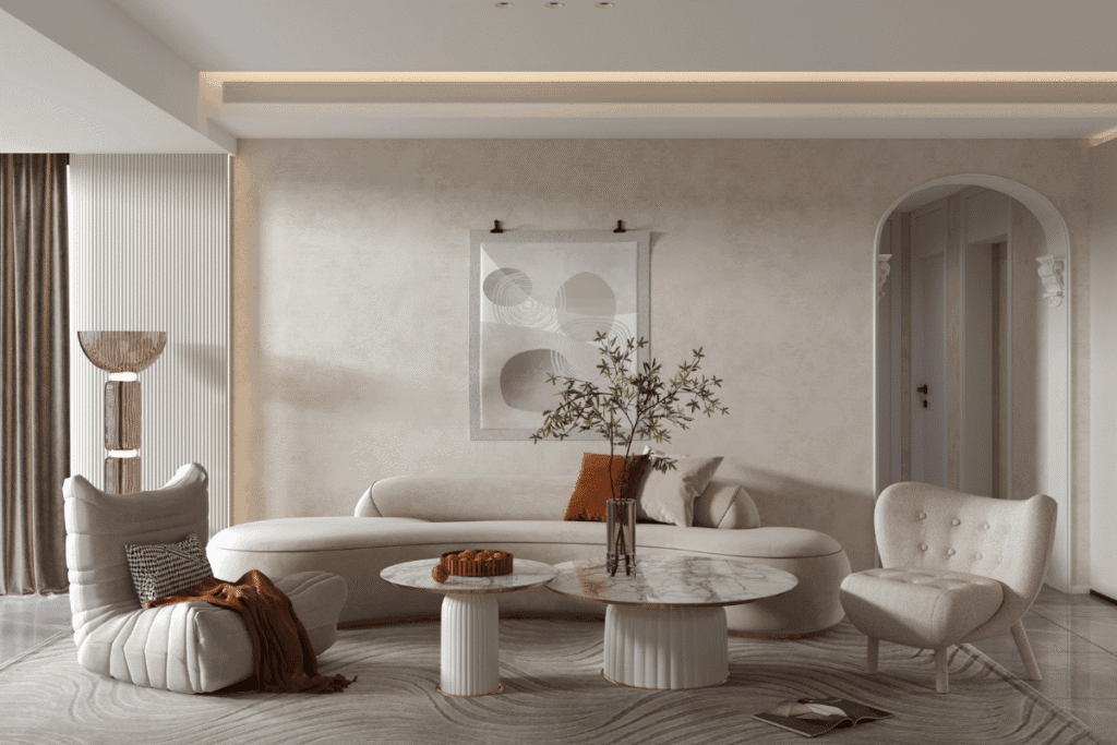 Neutral modern living room with sculptural armchairs and marble coffee tables